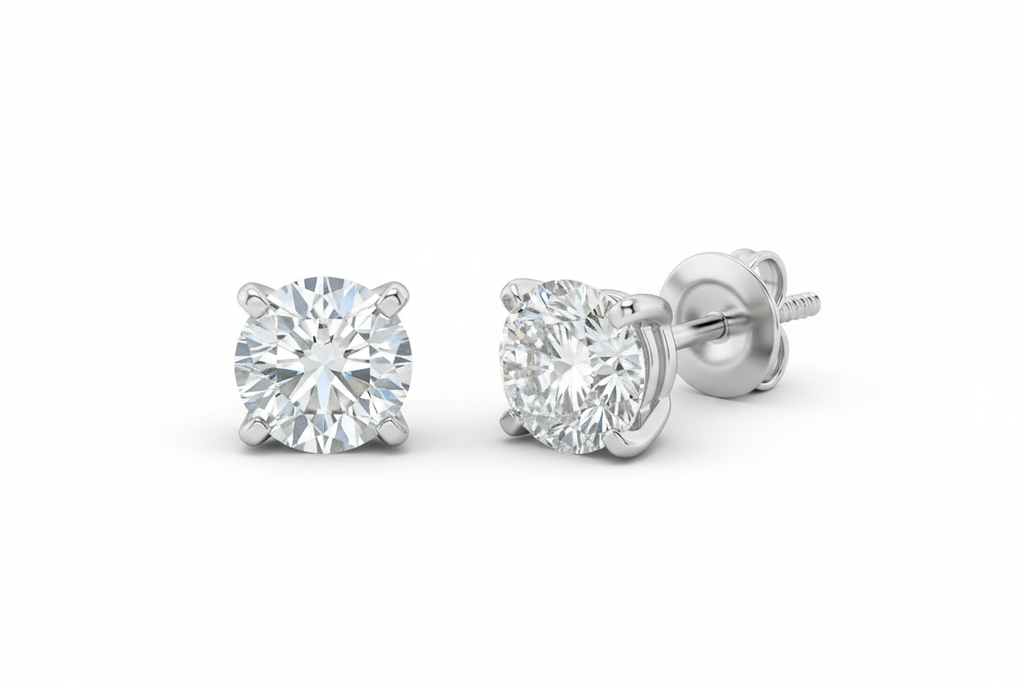 Create an image of round brilliant solitaire earrings with a four prong setting and screw on backings in white gold